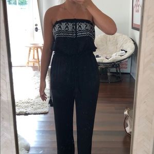 Black jumpsuit with white embroidered top